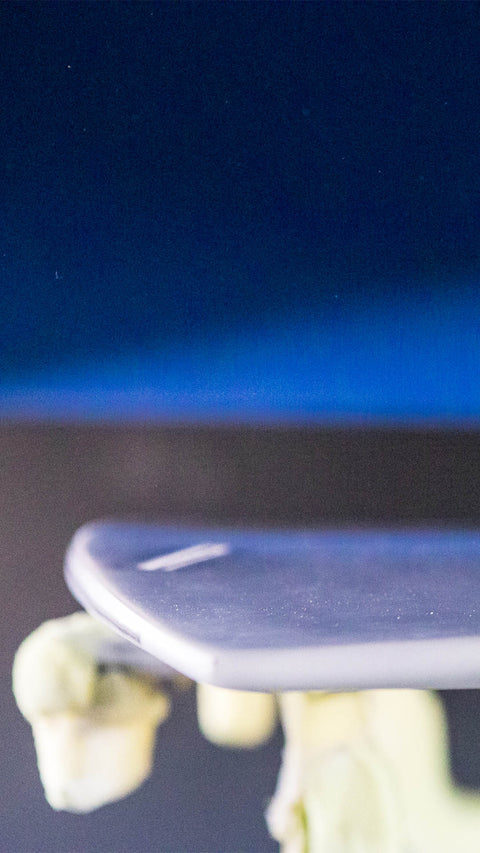 A dusty surfboard in a factory.