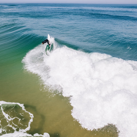 Surfer does a backside turn on a custom board
