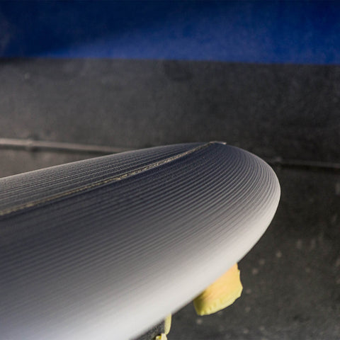 A surfboard blank after being cut by a CNC machine. 